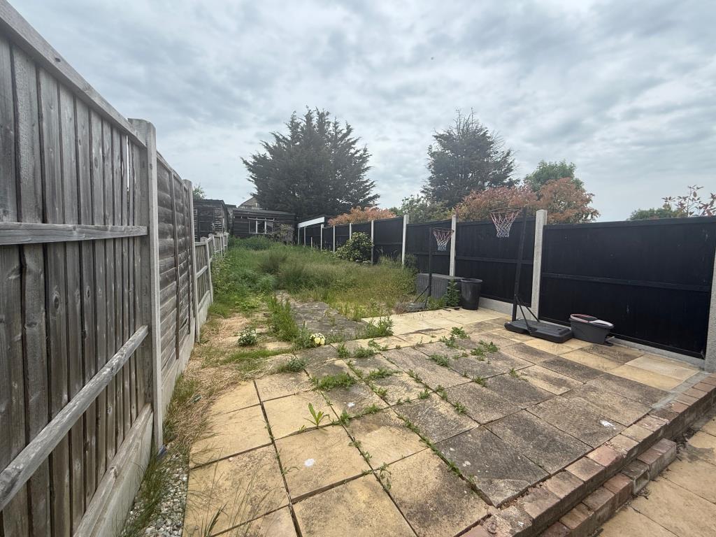Lot: 166 - MID-TERRACE HOUSE FOR IMPROVEMENT - Patio area leading to lawn